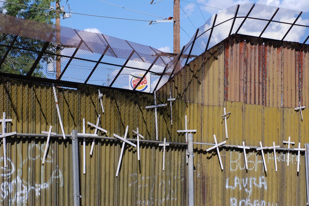 A wall of crosses on the border wall of Nogales.